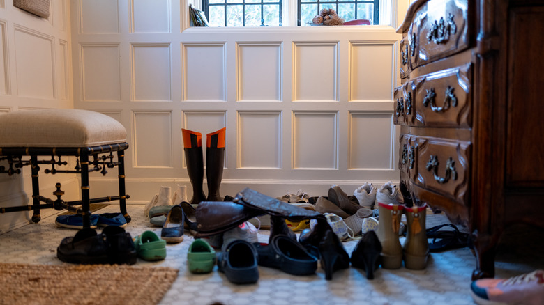 Pairs of shoes scattered around a room