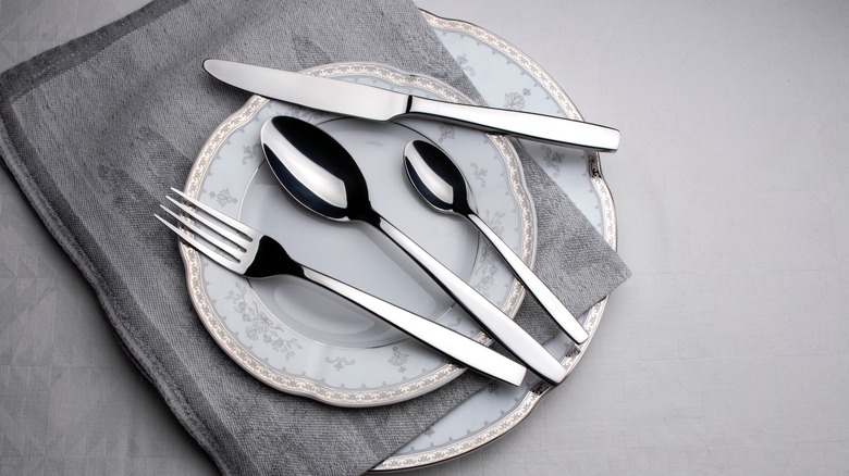 silver cutlery on a plate