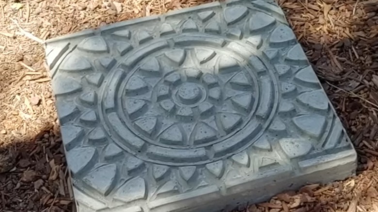 Cement stepping stone made with relief pattern from rubber doormat