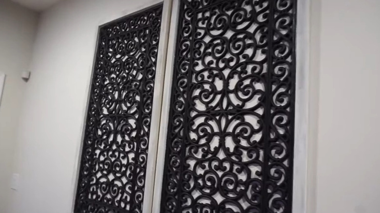 Framed black filigree rubber mat turned into wall art