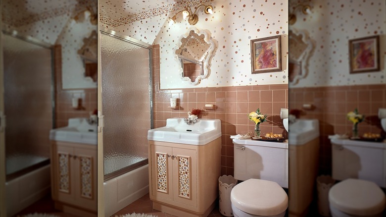 Maximalist bathroom with polka dots on walls and pink tiles