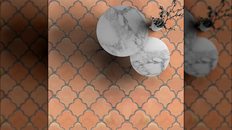 Fan-shaped terracotta tiles in an outdoor space with a table