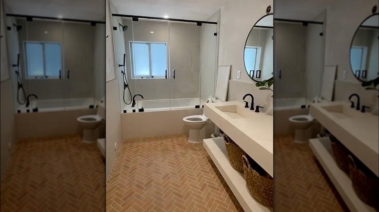 Herringbone pattern terracotta tiles in a modern bathroom