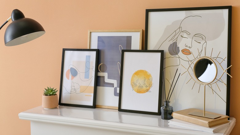 artwork layered on white shelf