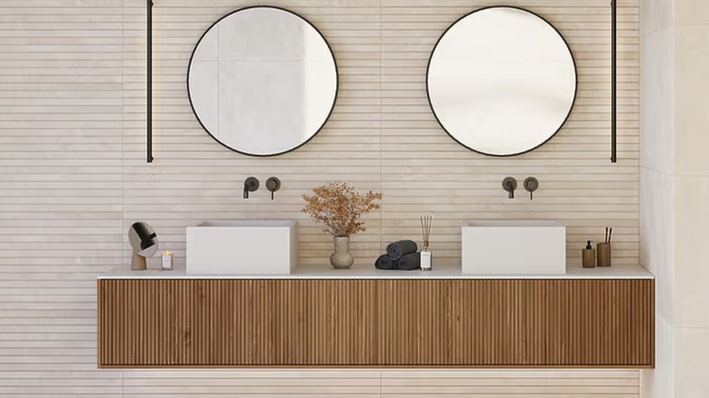 Double sink vanity with a fluted panel accent wall.