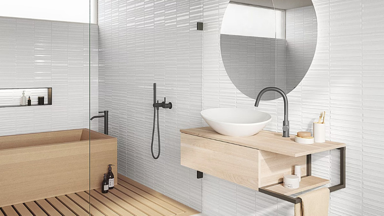 View of bathroom with ceramic fluted tile walls.