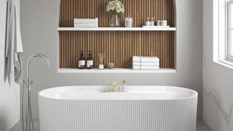 Fluted tile recessed shelf with fluted bathtub.