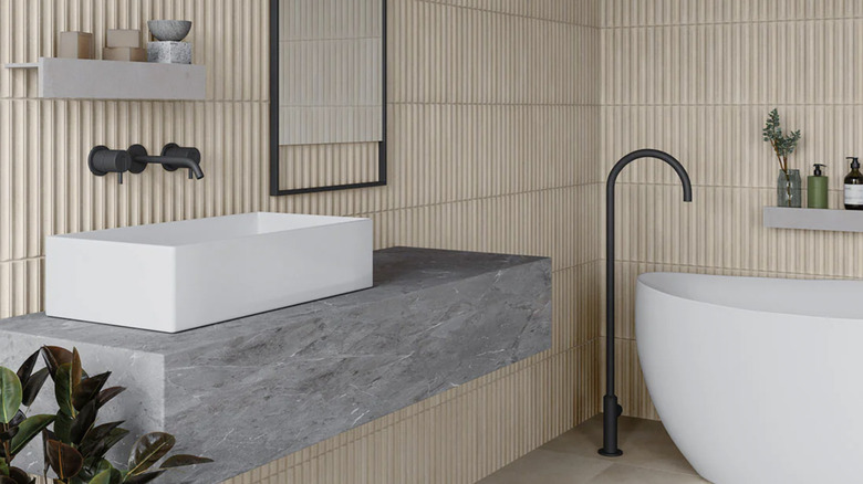 Modern bathroom with fluted tile walls.