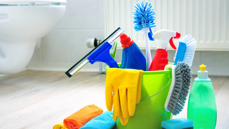 Cleaning supplies on bathroom floor