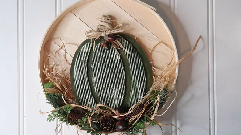 Fall wreath decor on a cheese box lid