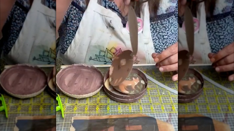 Crafter demonstrating accordion pull-out book in brie box