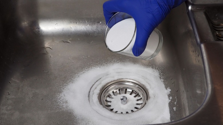 Sprinkling baking soda around the drain