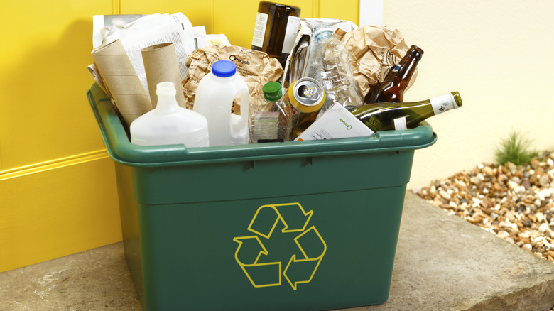 Recycling bin full of various items