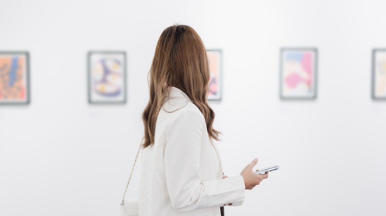 Woman in an art galley with white walls