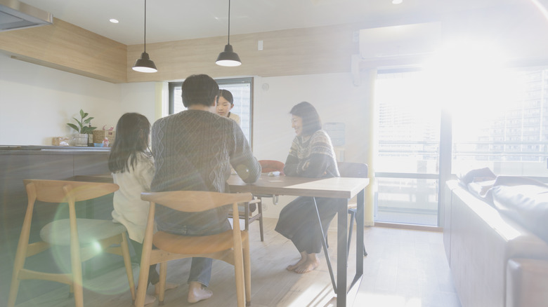 Family sitting in very bright living area