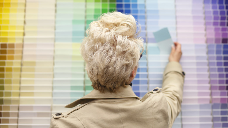 Woman picking out paint swatches