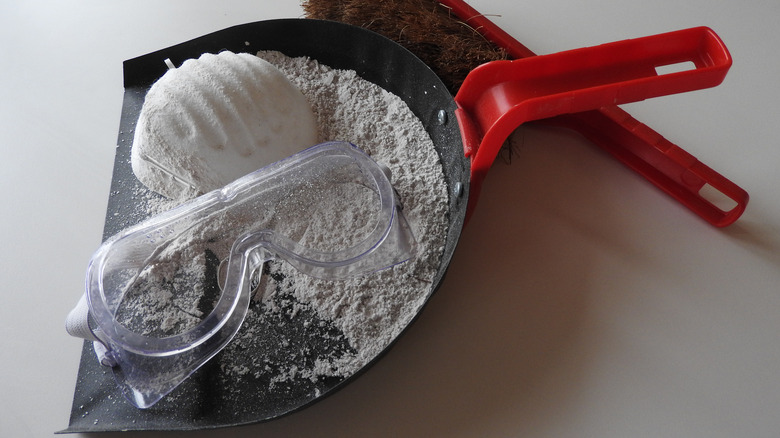 construction dust in dustpan