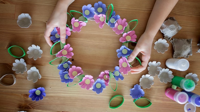 girl crafting colorful egg carton wreath