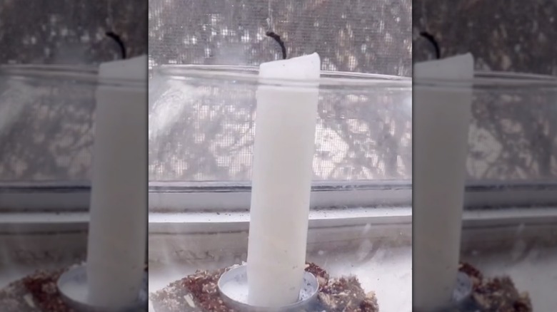 Tea light holder cup used to hold white taper candle