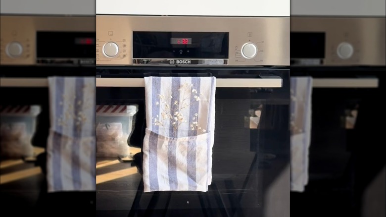 Striped towel holding a sprig of baby's breath