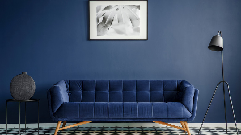 navy walls and navy couch in living room 