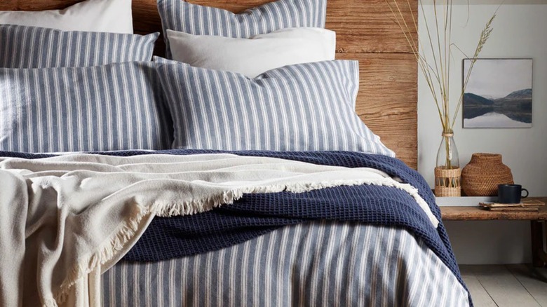 A striped blue and white duvet cover on a bed