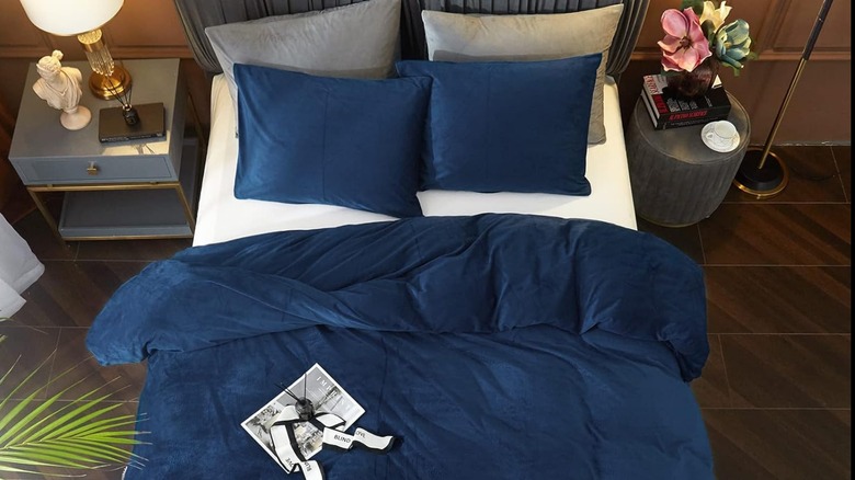 A blue velvet duvet cover on a bed