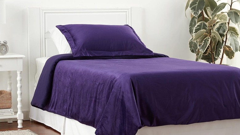 A purple duvet cover on a twin bed