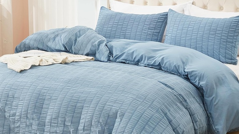 A blue microfiber duvet cover on a bed