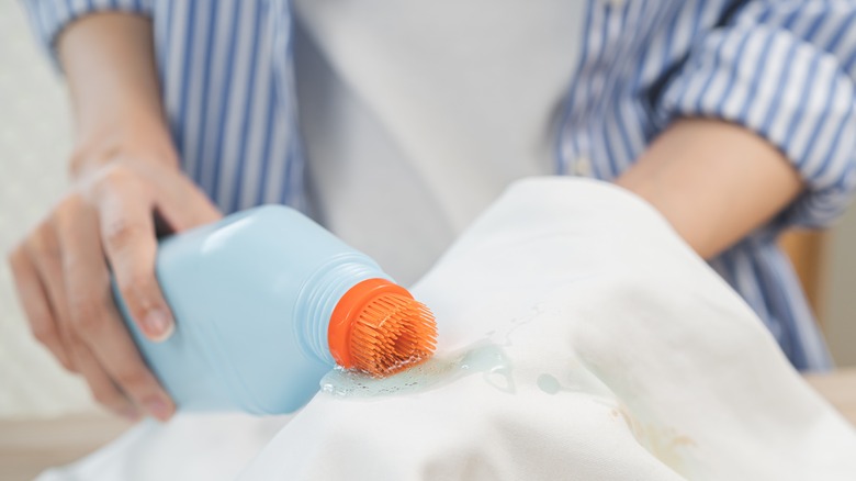 Applying stain remover on garment