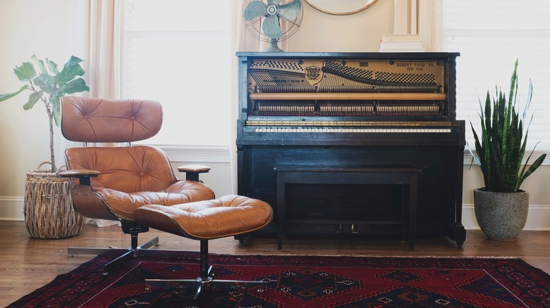 leather Eames chair beside piano