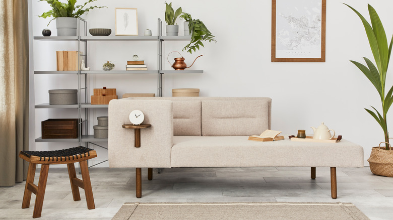 chaise lounge in front of a bookshelf