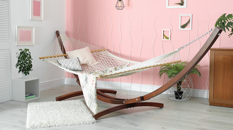 indoor hammock set against a pink wall