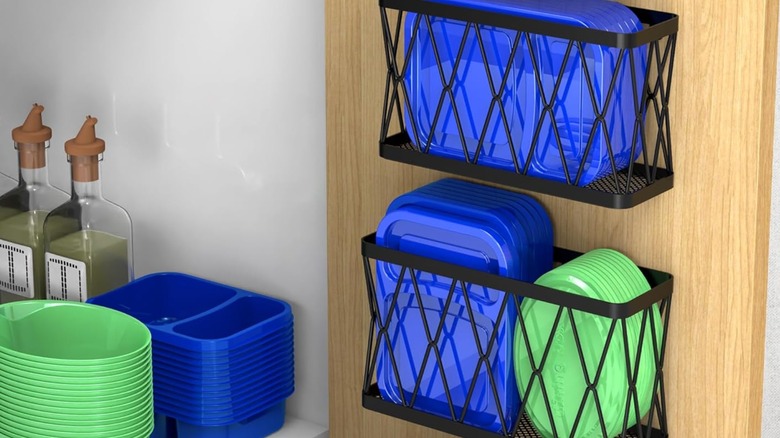 Mounted bins on inside of cabinet door holding plastic lids