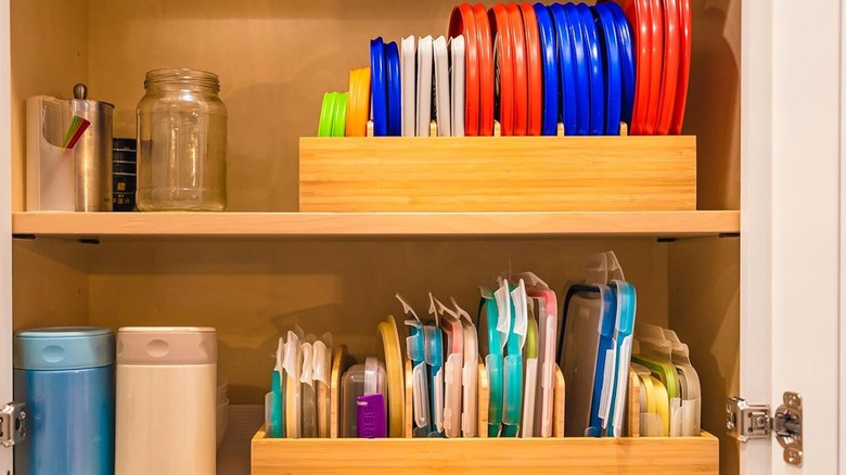 A cabinet with two plastic lid organizers