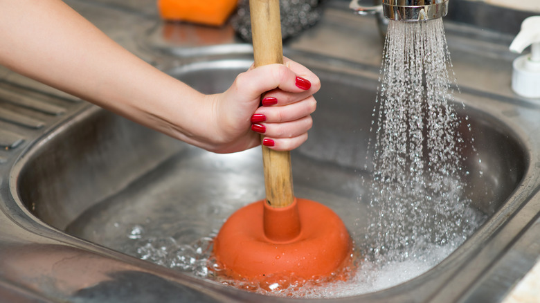 https://www.housedigest.com/img/gallery/10-genius-tips-for-fixing-a-slow-draining-sink/break-out-the-plunger-1631890173.jpg