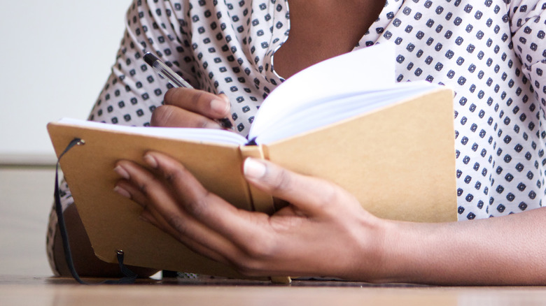 Woman sketching in notebook