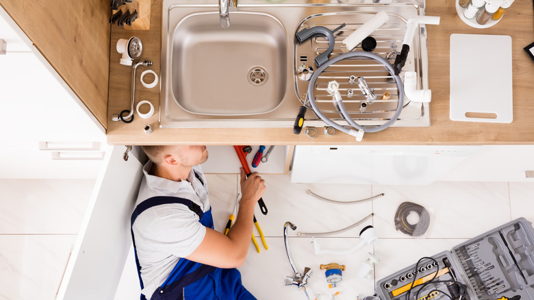 plumber fixing the clogged sink 