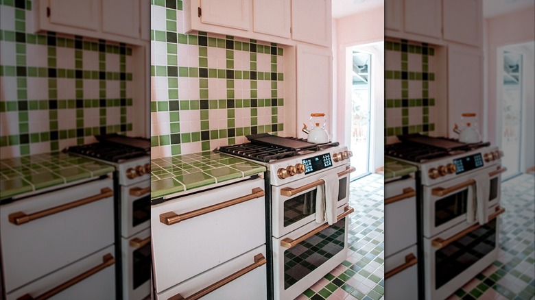 Colorful kitchen with green tile countertops and white appliances