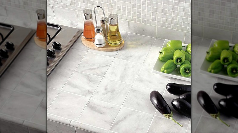 Marble tile countertops in a kitchen with cooking essentials