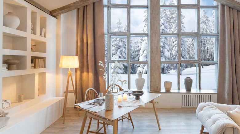 Cozy living area with large windows showing snow-covered landscape