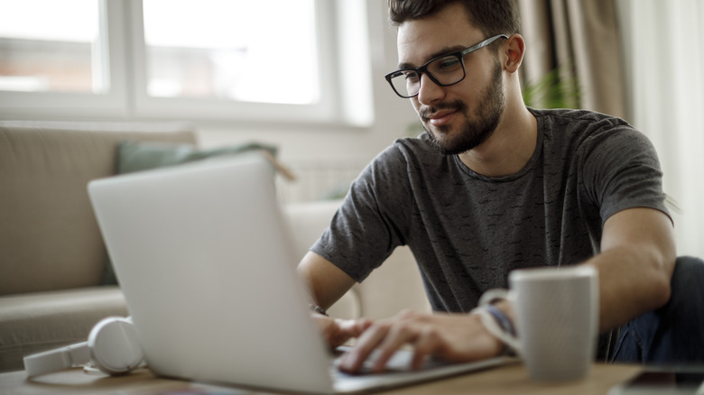 man researching on laptop