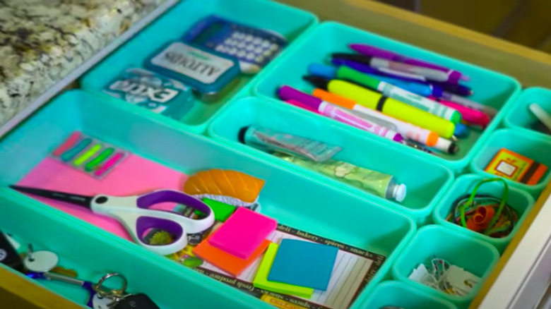 Teal organizers in junk drawer