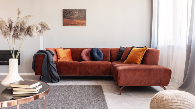 Copper brown sofa in a pale grey living room.