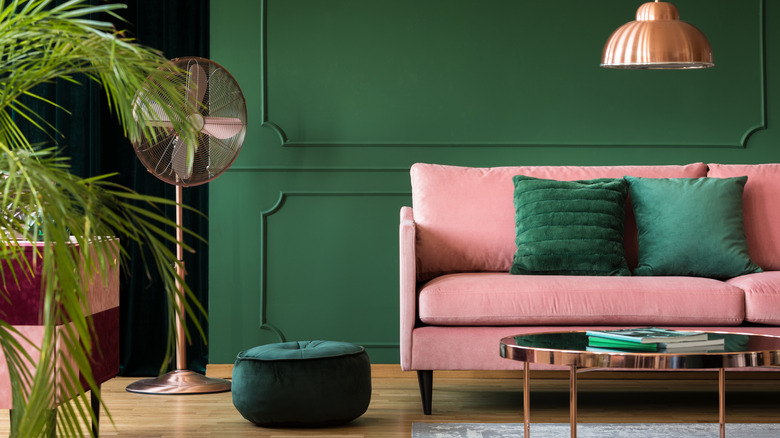 Malachite green walls with pink sofa.