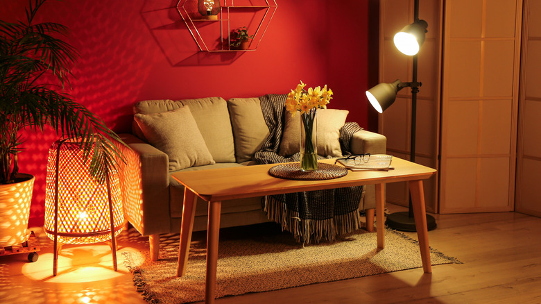 Red walls with taupe cushions on sofa.