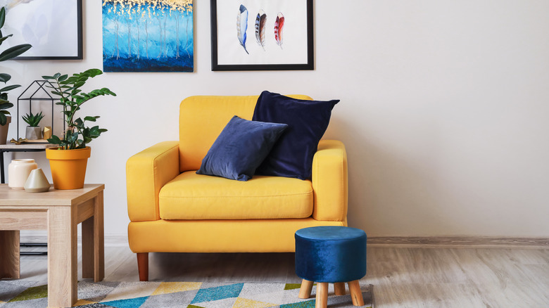 yellow armchair with blue pillows