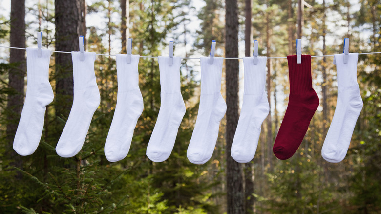 Different color socks hanging on a clothesline