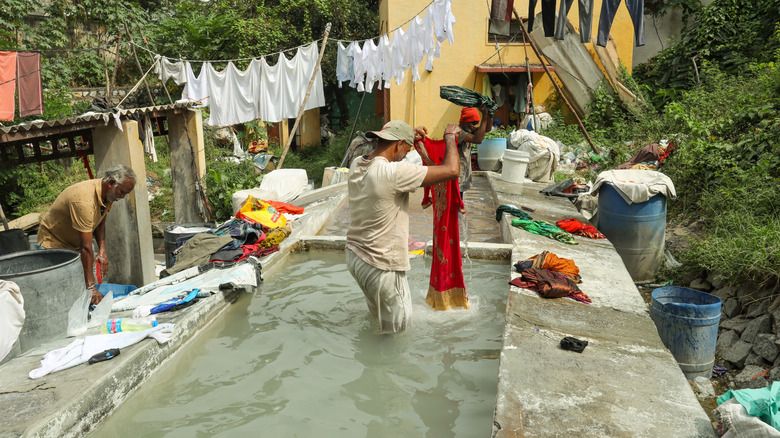 Washermen at a dhobi ghat washing clothes