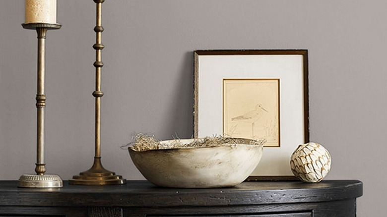 An image showing Polished Concrete behind a table with candles, a frame, and other decorations